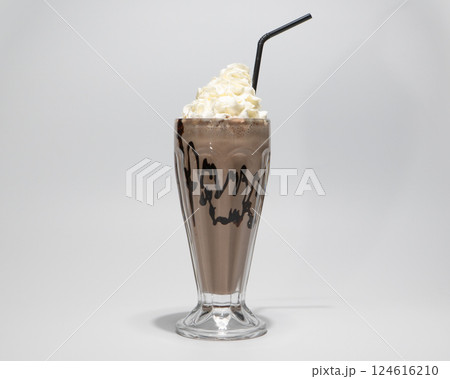 Delicious Creamy Chocolate Milkshake with Whipped Cream and Black Straw Isolated on White Background 124616210