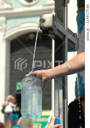 Filling Bottle at Outdoor Water Fountain on a Sunny Day Filling Bottle at Outdoor Water Fountain on a Sunny Day 124617586