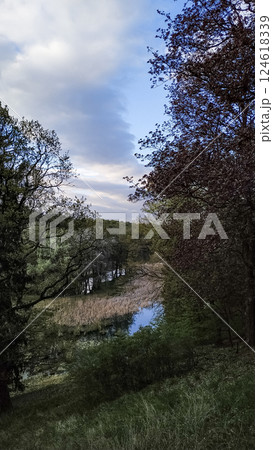 Scenic landscape of pruhonicky park in spring with cloudy sky, czech republic 124618339