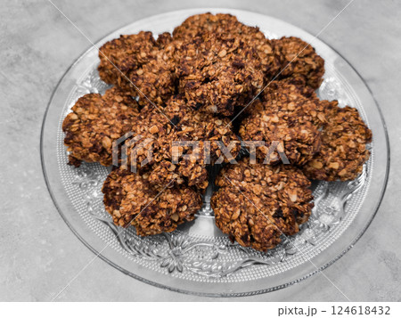 Delicious homemade oatmeal cookies resting on elegant glass plate copy space Delicious homemade oatmeal cookies resting on elegant glass plate copy space 124618432