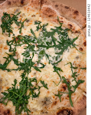 Delicious four cheese pizza with fresh arugula in prague 124618442