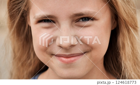 Smiling blond schoolgirl with blue eyes radiating joy and bright enthusiasm during classroom moment Smiling blond schoolgirl with blue eyes radiating joy and bright enthusiasm during classroom moment 124618773
