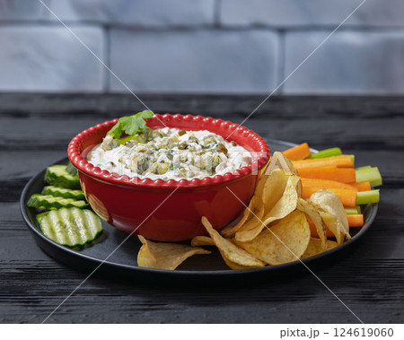 creamy yogurt pickles caper dill dip in red bowl 124619060