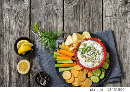 creamy yogurt pickles caper dill dip in red bowl 124619064