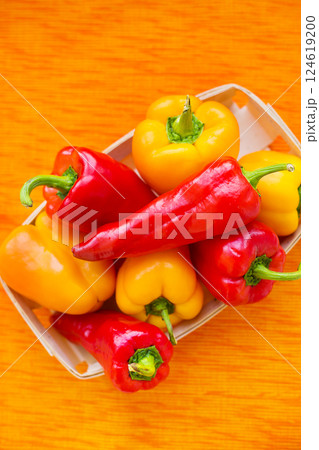 yellow and red peppers closeup on orange napkin 124619200