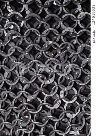 Detailed Close-Up of Interlocked Medieval Chainmail Rings. Intricate texture of metal links forming a strong and flexible defensive fabric. 124619635