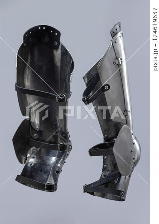 Steel Plate Leg Armor for Medieval Knight. Full leg protection with articulated segments from knee to ankle. 124619637
