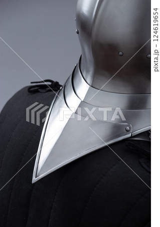 Shiny Metal Neck Guard Protection. Medieval armor detail showcases polished defense. Shiny Metal Neck Guard Protection. Medieval armor detail showcases polished defense. 124619654