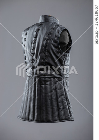 Black Leather Sleeveless Jacket with Lacing and Buckles. This image shows a black leather sleeveless jacket or vest with a high collar. It features decorative lacing details on the sides and 124619667
