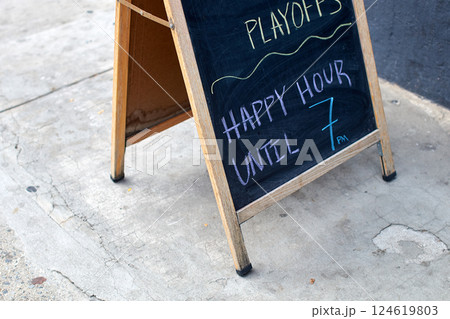 Happy hour advertisement written with chalk in New York City 124619803