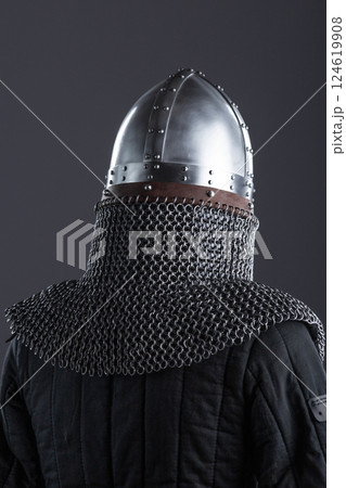 Simple Medieval Knight's Nasal Helmet with Chainmail. Classic head protection featuring a central nose guard and attached chainmail collar. 124619908