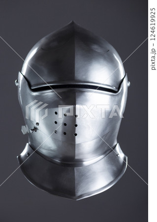 Polished Silver Medieval Armet Helmet with Perforated Visor. This shiny silver armet features a rounded skull, a protective bevor, and a visor with multiple small perforations. 124619925