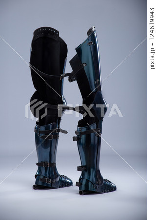 Shiny Steel Medieval Leg Armor. Full leg protection with straps and buckles detail. 124619943