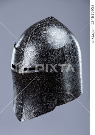 Darkened Steel Medieval Knight Helmet. Battle-worn head protection with narrow eye slits. 124619958