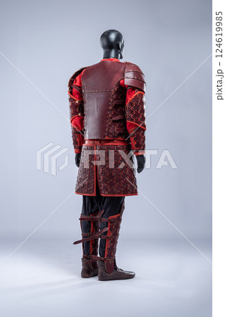Brown Leather Fantasy Armor Set for LARP Cosplay. Full costume on a mannequin with intricate details and red accents. Brown Leather Fantasy Armor Set for LARP Cosplay. Full costume on a mannequin with intricate details and red accents. 124619985