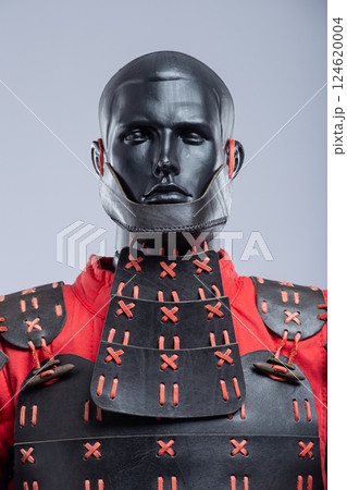 Black and Red Leather Armor Set on Mannequin. Full medieval warrior outfit with detailed stitching and metal accents. 124620004