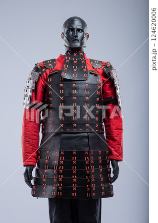 Black and Red Leather Armor Set on Mannequin. Full medieval warrior outfit with detailed stitching and metal accents. Black and Red Leather Armor Set on Mannequin. Full medieval warrior outfit with detailed stitching and metal accents. 124620006