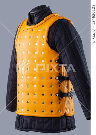 Bright Yellow Brigandine Armor with Studs. This image shows a bright yellow brigandine armor, featuring rows of silver studs and black straps with buckles on the sides. Bright Yellow Brigandine Armor with Studs. This image shows a bright yellow brigandine armor, featuring rows of silver studs and black straps with buckles on the sides. 124620125