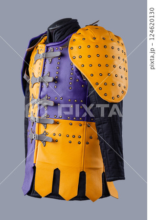 Colorful Brigandine Armor with Studs and Buckles. This image shows a vibrant piece of brigandine armor, featuring a combination of purple and yellow leather sections adorned with studs and secured Colorful Brigandine Armor with Studs and Buckles. This image shows a vibrant piece of brigandine armor, featuring a combination of purple and yellow leather sections adorned with studs and secured 124620130