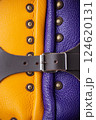 Close-Up of Colorful Brigandine Armor Details. This image provides a detailed close-up of the colorful brigandine armor, showcasing the studs, leather straps with buckles, and the contrasting purple 124620131
