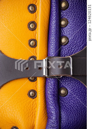 Close-Up of Colorful Brigandine Armor Details. This image provides a detailed close-up of the colorful brigandine armor, showcasing the studs, leather straps with buckles, and the contrasting purple 124620131