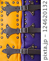 Close-Up of Colorful Brigandine Armor Details. This image provides a detailed close-up of the colorful brigandine armor, showcasing the studs, leather straps with buckles, and the contrasting purple 124620132