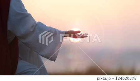 Jesus Christ hand silhouette, evangelism and salvation concept, bright sun and easter background 124620378