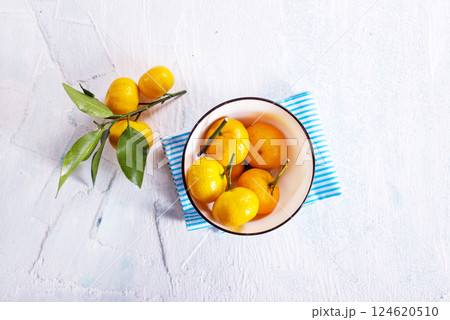 Fresh mandarin oranges fruit or tangerines with leaves on a table 124620510