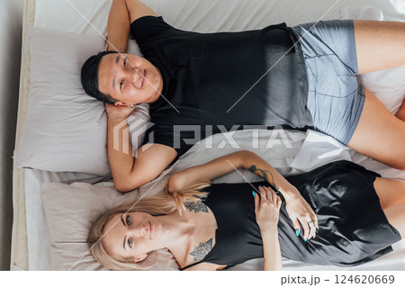 A man and a woman woke up in the morning in the bedroom on the bed 124620669
