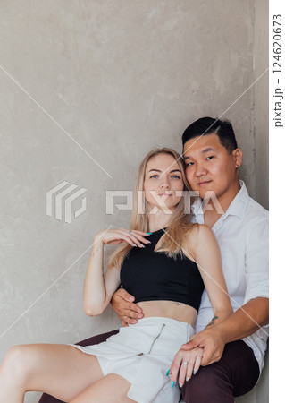 Man And Woman Sitting Together Side By Side Hugging And Smiling Man And Woman Sitting Together Side By Side Hugging And Smiling 124620673