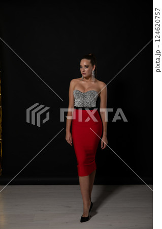 Beautiful fashionable woman in an evening dress for a holiday 124620757