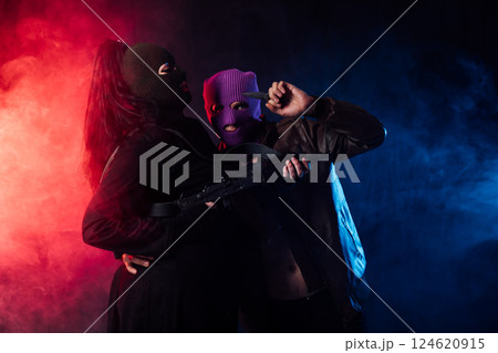 Man And Woman Bandits With Masked Guns 124620915
