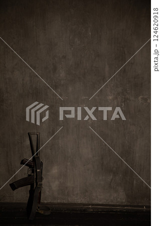 Weapon Assault Rifle Stands Against Dark Wall As Background Weapon Assault Rifle Stands Against Dark Wall As Background 124620918