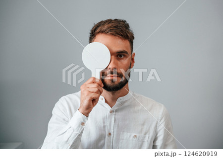 Test of sight. Man is checking his vision indoors in the clinic 124620919