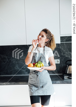 housewife preparing eating fruit in the kitchen for dinner 124620952