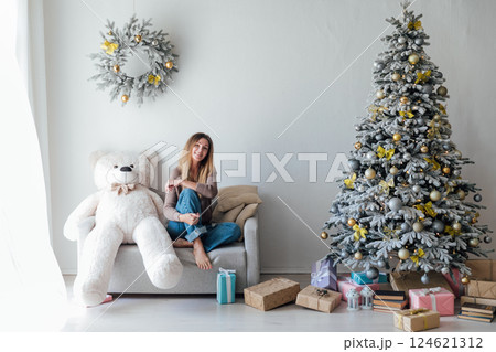 Woman with Bear Toy and Christmas Tree with New Year Gifts Woman with Bear Toy and Christmas Tree with New Year Gifts 124621312