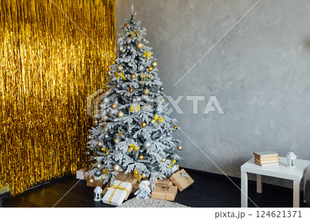interior with a white Christmas tree decorated with gifts garlands for the new year 124621371