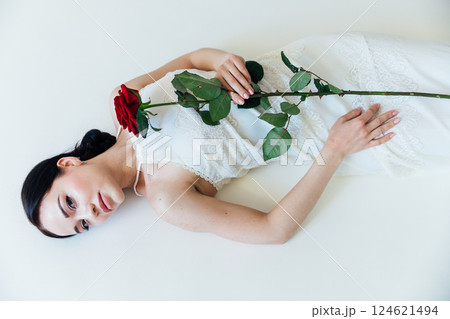 Beautiful Woman Brunette Bride in White Dress With Red Rose 124621494