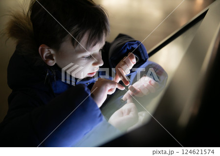 Little boy learning touch electronic information tablet 124621574