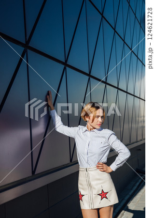 Portrait of a beautiful slender fashion woman in a blouse and skirt on a street walk Portrait of a beautiful slender fashion woman in a blouse and skirt on a street walk 124621728