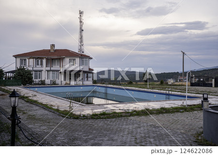 Unkempt and abandoned outside swimming pool near a residential house Unkempt and abandoned outside swimming pool near a residential house 124622086