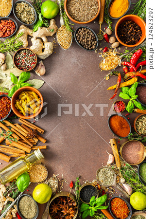 A colorful assortment of fragrant herbs and spices on a warm brown background, showcasing their visual variety and aromatic appeal, spice frame A colorful assortment of fragrant herbs and spices on a warm brown background, showcasing their visual variety and aromatic appeal, spice frame 124623297