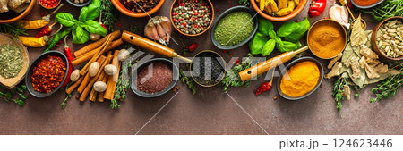 An elegant arrangement of spices and herbs in vivid colors, set against a brown surface, highlighting their aromatic richness and visual diversity, banner An elegant arrangement of spices and herbs in vivid colors, set against a brown surface, highlighting their aromatic richness and visual diversity, banner 124623446