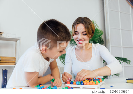 The teacher conducts educational games with a constructor The teacher conducts educational games with a constructor 124623694