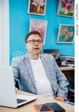 Business man working online learning on laptop at desk in office 124623969