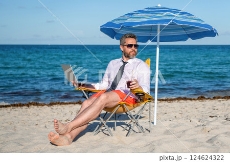 Man freelance worker online at sea beach. Businessman on summer. Online freelance work. Businessman worker with laptop. Business man use laptop in beach. Travel and business. Corporate travel policy 124624322