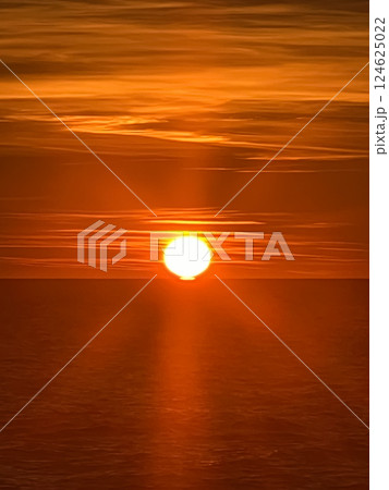 Red sun setting over the sea 124625022