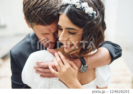 Embracing each other. Beautiful bride with his fiance is celebrating wedding outdoors 124626201
