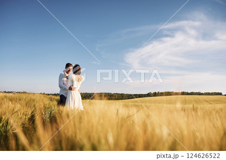 Conception of love. Couple just married. Together on the majestic agricultural field at sunny day 124626522