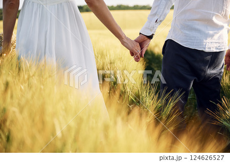 Standing and enjoying the nature. Couple just married. Together on the majestic agricultural field at sunny day 124626527